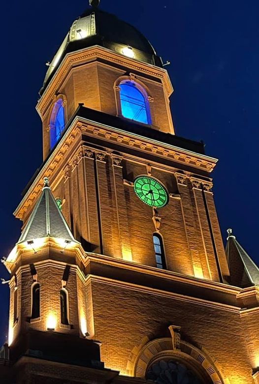 Lewiston City Hall with the clock face lit green